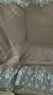 Net saree with heavy embroidered blouse and border