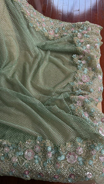 Net saree with heavy embroidered blouse and border