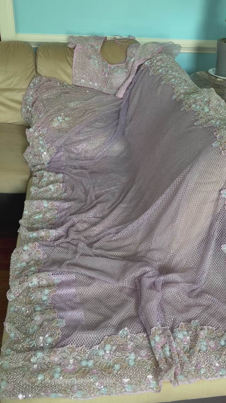 Net saree with heavy embroidered blouse and border