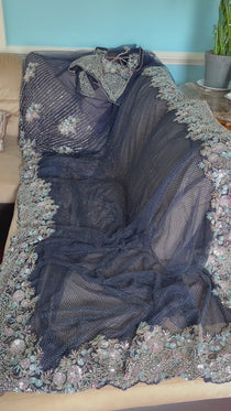 Net saree with heavy embroidered blouse and border