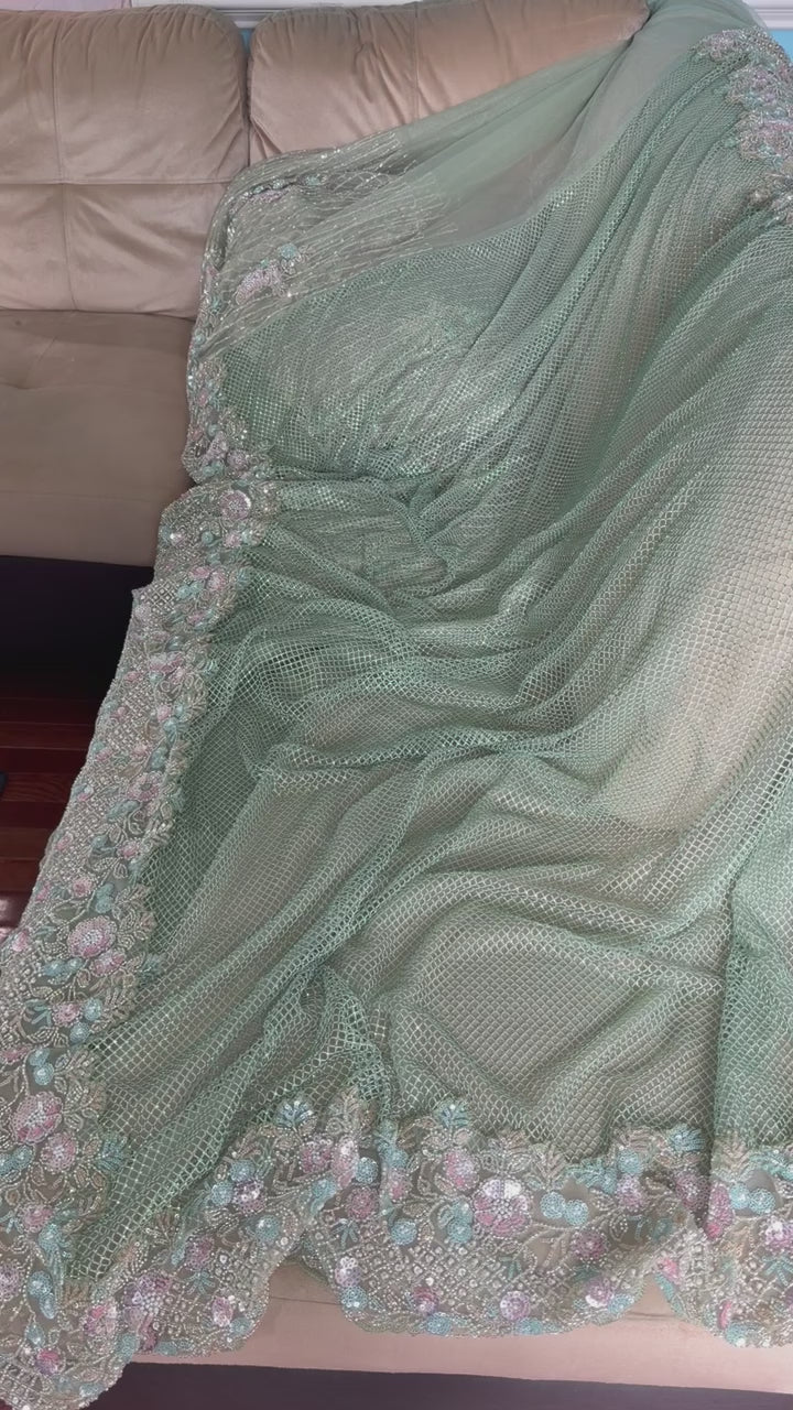 Net saree with heavy embroidered blouse and border